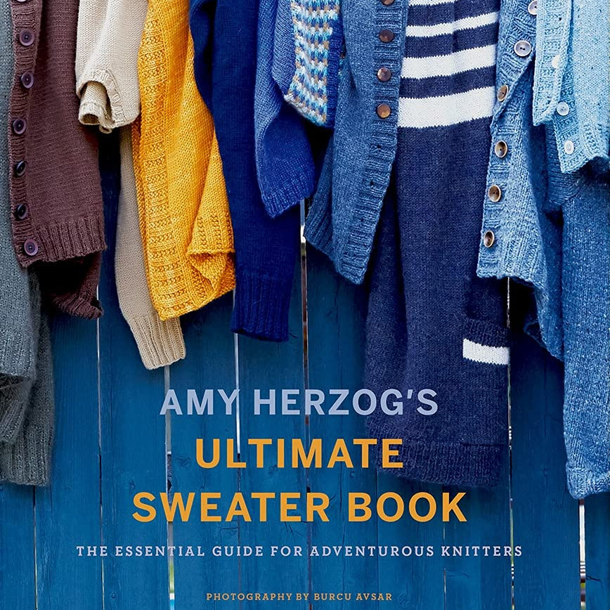 Image of "Ultimate Sweater Book" - a beautiful display of sweaters hung over a blue fence.  A full-color comprehensive guide to knitting sweaters and designing and modifying sweater patterns, by Amy Herzog, the author of You Can Knit That, Knit to Flatter, and Knit Wear Love.